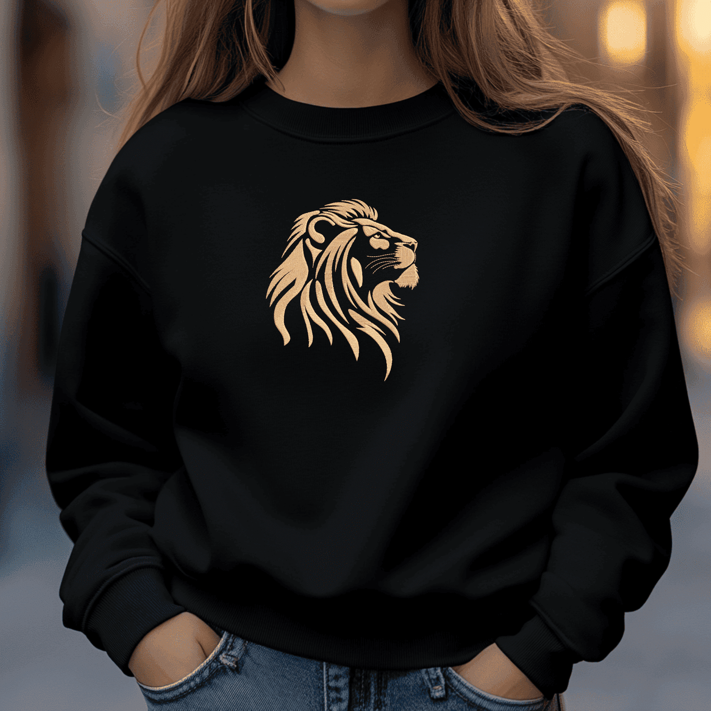 Golden lion head embroidery design with layered mane details on a black textile background.