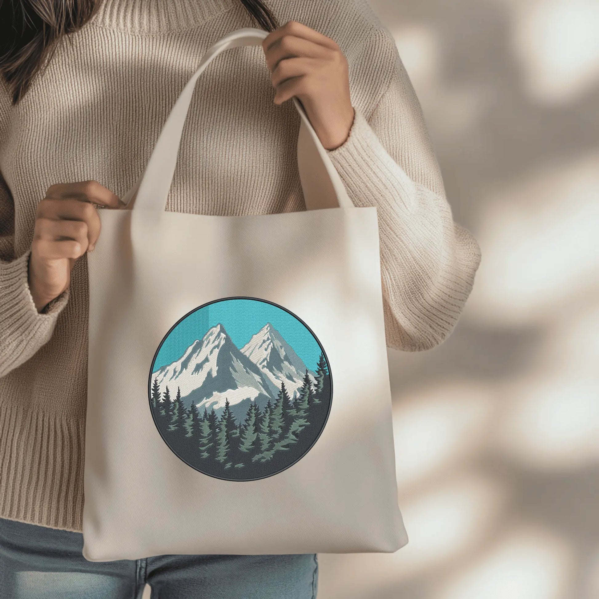 Detailed alpine embroidery scene featuring mountain clouds and a dense evergreen forest.