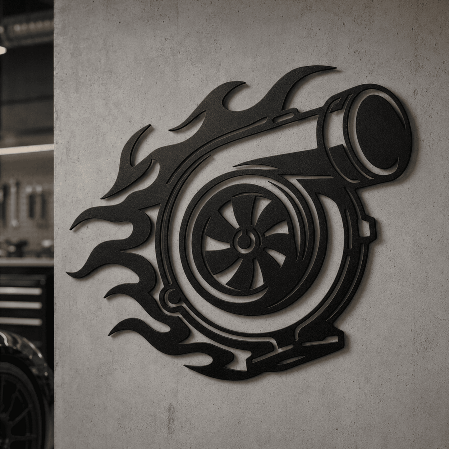 Black turbocharger metal wall art displayed in a modern garage